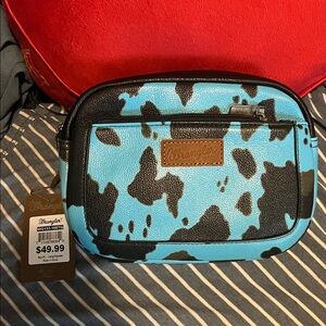 Wrangler Turquoise and Black Cow Print Crossbody Bag with adjustable strap.
